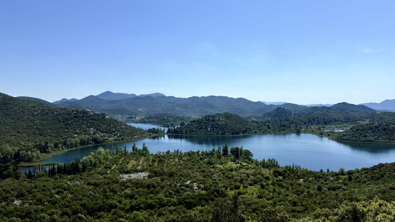 Blue lakes surrounded by green hills on the journey through southern Croatia