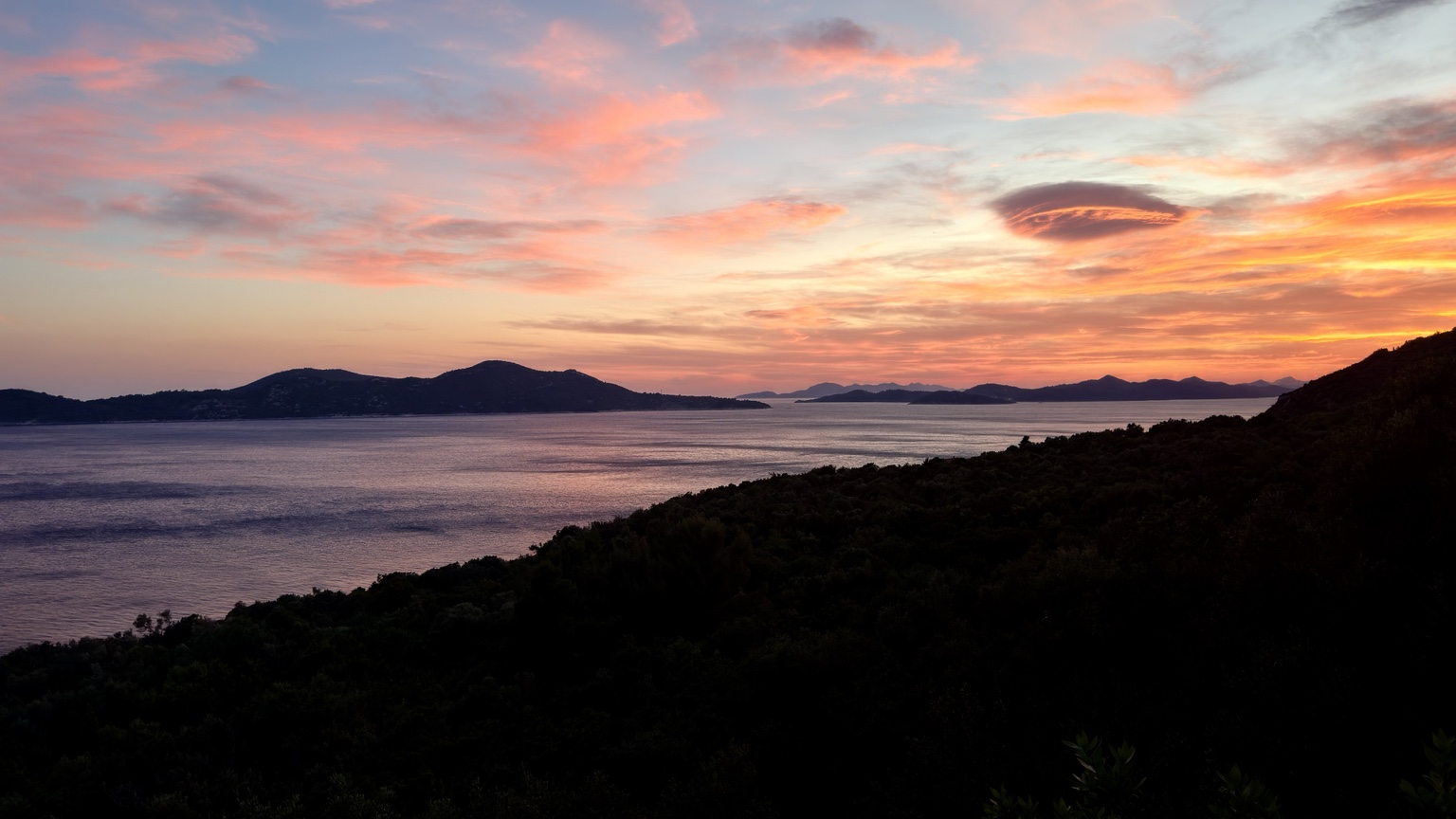 A vivid pink and orange sunset over the Adriatic and islands near Dubrovnik
